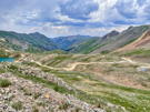 Looking down the valley with a lake, road and distant mountain peaks