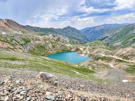 Looking down the valley with a lake, road and distant mountain peaks