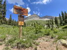 Trail sign with granit peaks in the distance
