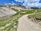 Road going by Writes Lake with mountains in the background