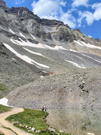 People fishing in Writes Lake with massive mountain behind and large rocky slopes