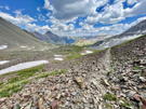 Rocky stretch of the trail dropping into a mountain valley