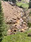 A stream tumbing down over a rocky surface