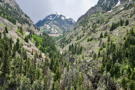 Highway going up through a mountain gorge with a mountain peak in the distance