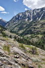 A view up Uncompahgre Gorge towards Red Mountain pass with a road showing on a corner