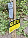 A Caution Active Blasting Site Ahead sign on the trail