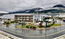 Buildings in Juneau below a forest mountain shrouded in clouds