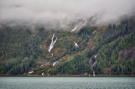 Waterfalls dropping below the clouds