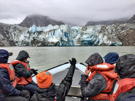 Our skiff guide gesturing towards North Sawyer Glacier as she attempts to teach us