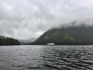 Our ship waits for our return with clouds and forests in the background