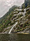 One of the kayaks pauses to take in yet another dramatic waterfall