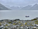 Our ship in the background (tiny on the left) and the skiff that brought us to the glacier hike