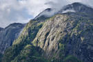 Massive granite cliffs with a cloud shroud near the top