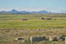 Farm below volcanic mountains and icesheet