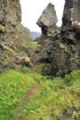 The trail goes under one of the spires with the overhang