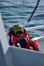 Whale watching is a cold and tiring experience; watcher taking a nap