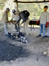 Putting the food for the Pachamanca into the hot stones