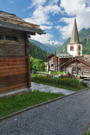 Hike starts through town, looking back at old wood buildings and the Roman Catholic Church