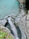 Waterfall coming out of a pool of glacial water