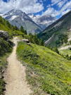 The trail continues down the side valley